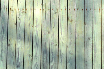 peeling green wooden fence boards