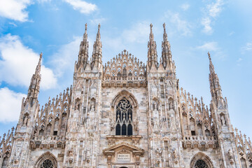 Architectural gothic detail with the facade of the iconic Milan Cathedral or Duomo di Milano, the...