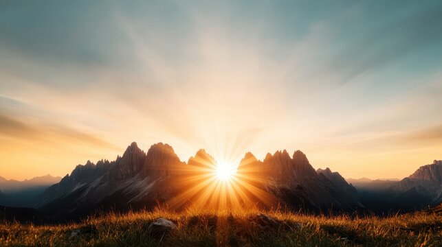 A breathtaking view of the sun rising behind dramatic mountain peaks, casting vibrant rays and illuminating the landscape, creating a sense of serenity and wonder.
