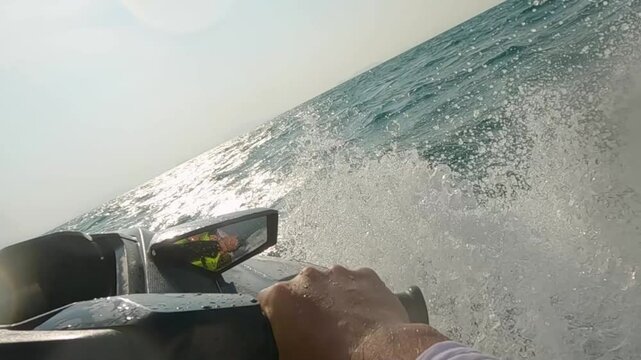 tourists riding a jet ski in the sea at sunset splashing. white clothes
