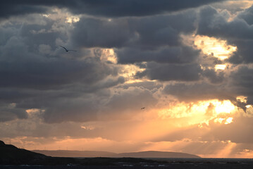Spectacular cloudy sky over the seashore at sunset