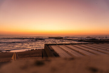 Twilight with an orange sky over the Atlantic Ocean shore