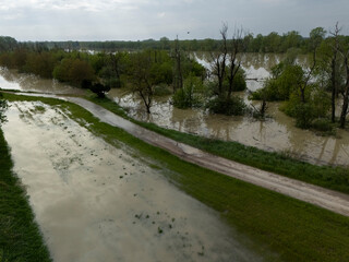 Flooding Po River submerging agricultural landscape near Olza, Emilia Romagna, saturating fields,...