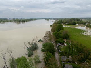 Flooding muddy waters overwhelming rural landscape near Po River in Emilia Romagna, Italy,...
