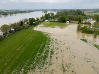 Muddy water is covering fields and approaching houses near the overflowing Po River in Emilia...
