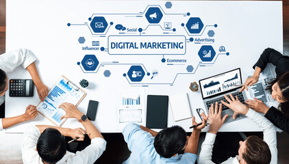 A diverse team engages in a collaborative business meeting focusing on digital marketing strategies, analyzing data trends using various devices and tools. Amity