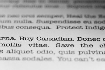Buy Canadian. Text printed on a page. A piece of paper with a phrase written in retro typewriter...