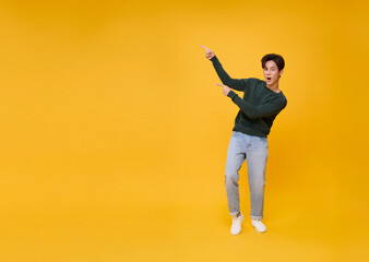 handsome asian man pointing finger to present something his hand gesture are perfect for the...