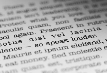 Speak louder. Encouraging text printed on a page. A piece of paper with a phrase written in retro typewriter font.