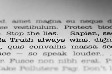 Stop the lies. Truth always wins. Text printed on a page. A piece of paper with a phrase written in...