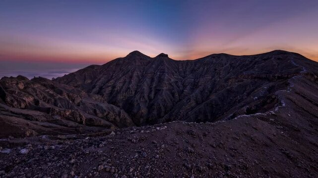 Time-lapse footage of a sunset transitioning from day to night over the volcanic caldera of Tejeda in Gran Canaria, Canary Islands, Spain