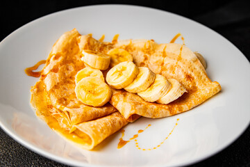 Crepes banana syrup pancakes breakfast dish dessert organic product fresh tasty gourmet food background on the table rustic food top view copy space