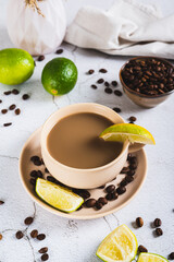 A cup of latte infused with lime on the table vertical view