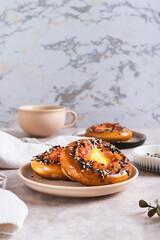 Baked bagels with tomato and quail egg on a plate on the table vertical view