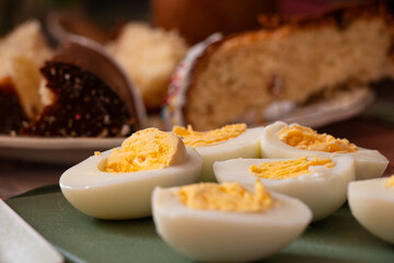 Cut boiled eggs and Easter cake on a festive table in Ukraine for Easter, Easter