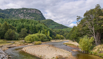 Autumn landscape in a hiking trail among mountains, forests and rivers of the wild nature in Chilean Patagonia. Tourism along the road 7 Carretera  Austral. 