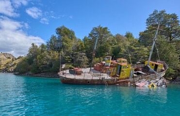 Abandoned ship in General Carrera Lake in Chile - remains of the closed mining industry. A ship located in a way of the boat tour to Marble Caves, attraction in the region.