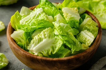 Fresh chopped romaine lettuce in wooden bowl