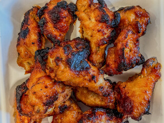 Naked Barbecued Chicken Wings On A White Background
