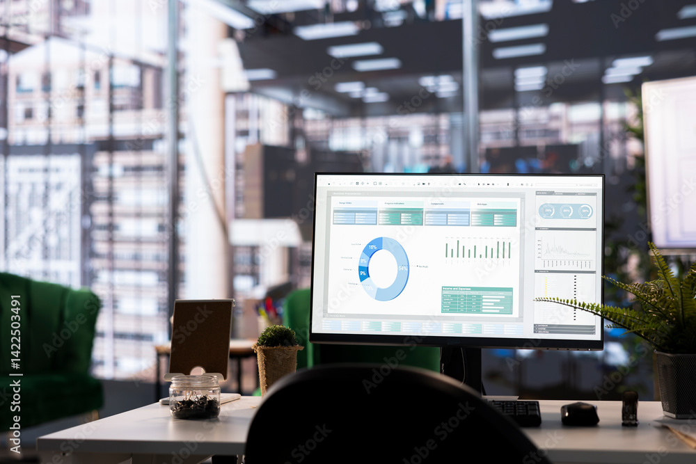 Aufkleber modern office desk displays financial data on a monitor. the detailed analytics and graphs highlight