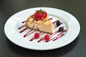 Slice of cake or cheesecake with strawberry jam decorated with red berries, dessert, food