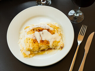 Appetizing rolls with minced meat, cheese and sauce. Traditional Italian dish Canelone de carne