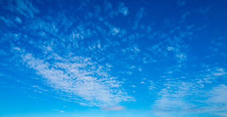 White clouds on blue sky. Beautiful sunny sky. Background with clouds on blue sky. Clouds on sky pattern.
