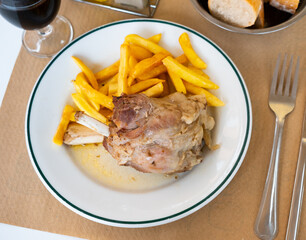 Delicious roasted pork knuckle served with vegetable garnish of fried potatoes ..