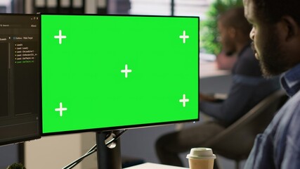 Programmer utilizing green screen computer to train machine learning models, zoom in shot. Close up...