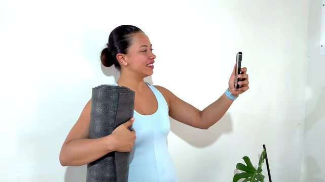 Yoga instructor making a video call on white background