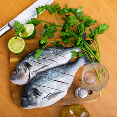Dorado fish dish with lime slices and cilantro sprig