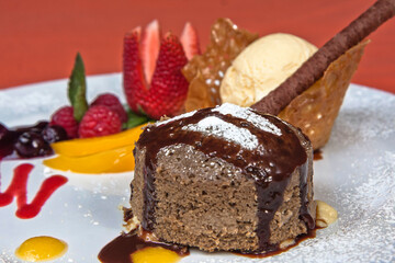 Delicious chocolate fondant with red berries and peach with vanilla ice cream, desserts
