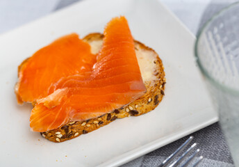 One sandwiches with white bread butter and smoked salmon