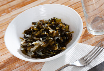 Traditional Japanese cuisine dish of spicy pickled oarweeds with onions served as snack..