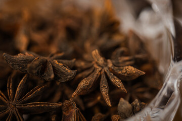Estrellas de anís desprenden su aroma característico, aportando calidez y elegancia a la atmósfera del lounge en una foto macro con luz suave
