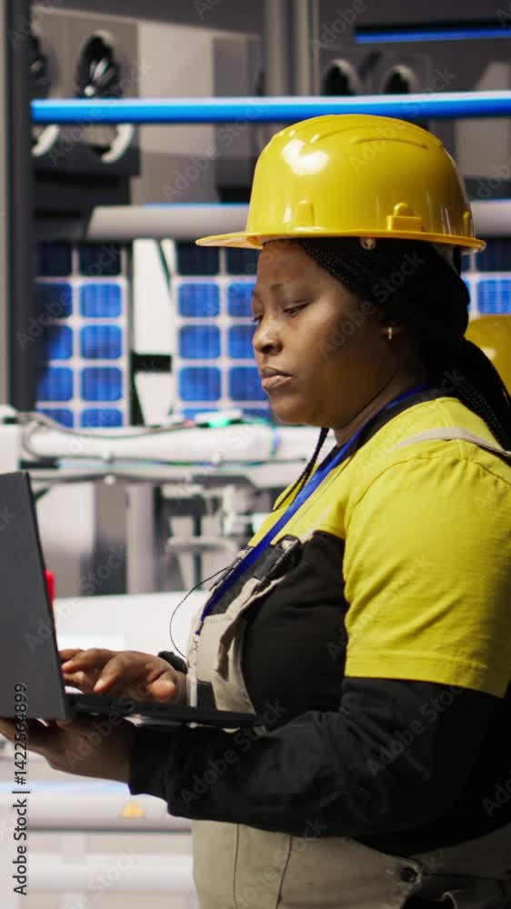 Poster vertical video engineer walking in smart factory, using laptop to analyze iot sensors data, refining