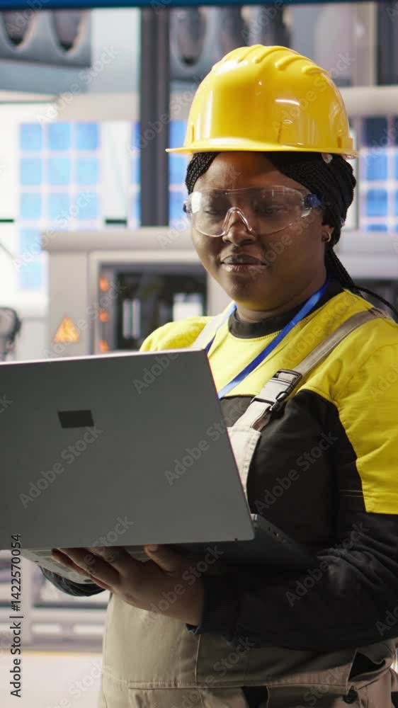 Poster vertical video engineer performing predictive maintenance using laptop, analyzing iot sensor data, m
