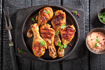 Tasty roasted chicken leg as summer delicacy in sunny day.