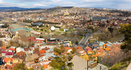 Panorama of historic center of Tbilisi city on banks of Mtkvari River on sunny spring day, Georgia © JackF