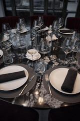 Champagne tasting, Wine glasses are on the table, stylish table setting, wine is poured from a bottle and decanter, sparkling wine bubbles, snacks, people smell the aroma and taste the wine