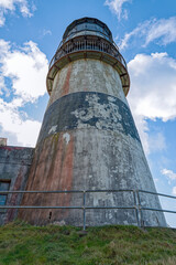 Paint peels from the weathered tower of the lighthouse at Cape Disappointment State Park, Ilwaco, Washington, USA