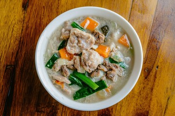 Steaming Bowl of Sinigang with Fresh Vegetables in Tamarind Broth