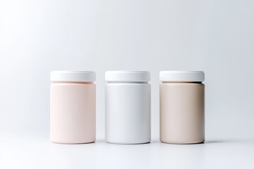 Three blank pill bottles in pastel colors
