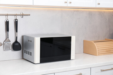 Closed microwave oven on counter in kitchen