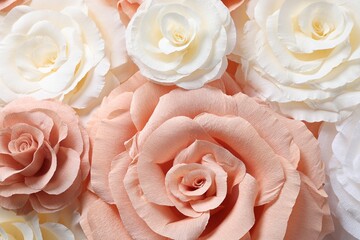 Beautiful paper flowers as background, top view