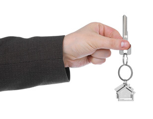 Real estate agent holding key with house shaped keychain on white background, closeup