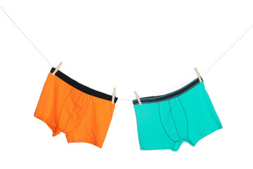Comfortable men's underwear on clothes line against white background