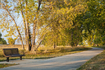 bench and recreational biking trail in Boyd Lake State Park near Loveland, Colorado, fall scenery