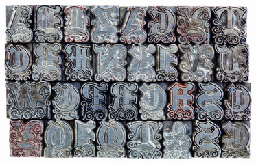 random alphabet letters in decorative metal letterpress type - initials font - stained by color inks