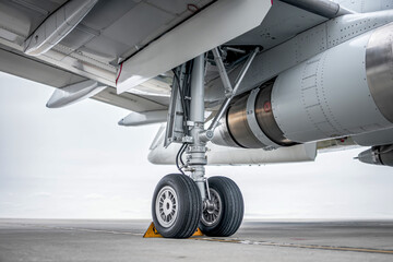 A powerful jet engine with a visible propeller sits on the wing of an airplane at the airport, ready for aviation and flight